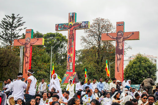 Crowds gathered beneath decorated crosses during Ethiopian Easter, celebrating vibrant cultural and holiday traditions.