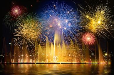 Fireworks light up the night sky over a waterfront fountain, celebrating New Year for an Ethiopian Airlines holiday feature.