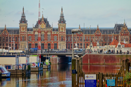 Amsterdam Central Station with canal view during autumn in the Netherlands
