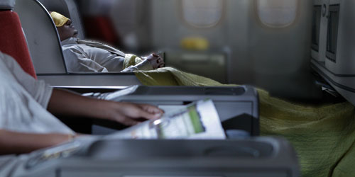 passengers on flight reading magazine